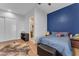 Cozy bedroom with wood floors and a bright blue accent wall at 38024 N 15Th Ave, Phoenix, AZ 85086