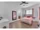 Bright bedroom features wood floors, a ceiling fan, and a large mirror at 38024 N 15Th Ave, Phoenix, AZ 85086