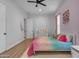 Colorful bedroom with wood floors, ceiling fan, and a bright accent wall at 38024 N 15Th Ave, Phoenix, AZ 85086