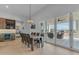 Dining area with wooden table, bar with wine fridge, and sliding glass doors to the outdoor patio at 38024 N 15Th Ave, Phoenix, AZ 85086