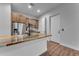 Modern kitchen with stainless steel appliances, unique stone countertop, and contrasting wood and white cabinetry at 38024 N 15Th Ave, Phoenix, AZ 85086