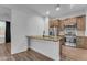 Well-lit kitchen with stainless steel appliances, countertop dining space, and wood cabinets at 38024 N 15Th Ave, Phoenix, AZ 85086