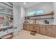 Spacious pantry features wood cabinets, open shelves, sink, and room for storage at 38024 N 15Th Ave, Phoenix, AZ 85086