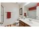 Bathroom featuring a single sink vanity, large mirror, and a shower with glass door at 3967 E Hematite Ln, San Tan Valley, AZ 85143