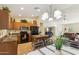 Well-lit kitchen with black appliances, a breakfast bar, and views of the living area at 3967 E Hematite Ln, San Tan Valley, AZ 85143