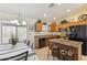 Open kitchen with black appliances, a center island, and a view to the dining area at 3967 E Hematite Ln, San Tan Valley, AZ 85143