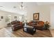 Cozy living room with leather sofas, a ceiling fan, and wood-look flooring at 3967 E Hematite Ln, San Tan Valley, AZ 85143