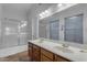 Bright bathroom with dual sinks, tile floor, bathtub, and large mirror at 4165 W Park Ave, Chandler, AZ 85226