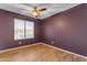 Bedroom with wood-look floors, ceiling fan, and view from the window at 4165 W Park Ave, Chandler, AZ 85226