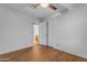 Bedroom with a ceiling fan, wood-look floors, closet, and view into the bathroom at 4165 W Park Ave, Chandler, AZ 85226