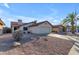 Beige single-story home with a tile roof, desert landscaping and attached garage at 4165 W Park Ave, Chandler, AZ 85226