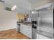 Kitchen area with stainless steel refrigerator, gray backsplash and granite countertops at 4165 W Park Ave, Chandler, AZ 85226