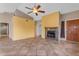 Open living room featuring tile floors, fireplace, and vaulted ceiling with ceiling fan at 4165 W Park Ave, Chandler, AZ 85226