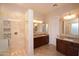 Spacious bathroom with dual vanity sinks, granite countertops, and a tiled shower with modern fixtures at 4251 E Desert Forest Trl, Cave Creek, AZ 85331