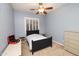 Comfortable bedroom featuring a ceiling fan, window with shutters, and a dresser with a vintage record player at 4251 E Desert Forest Trl, Cave Creek, AZ 85331