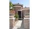 Inviting front entrance with stone turret, gated walkway, and potted succulents at 4251 E Desert Forest Trl, Cave Creek, AZ 85331