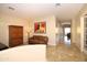 Hallway showcasing travertine floors, arched doorway, and a glimpse into other living spaces at 4251 E Desert Forest Trl, Cave Creek, AZ 85331