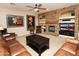 Cozy living room with a stone fireplace, built-in shelves, and comfortable leather seating at 4251 E Desert Forest Trl, Cave Creek, AZ 85331