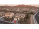 Aerial view of a home in a desert community, showcasing the neighborhood and mountain views at 43805 N Ericson Ln, New River, AZ 85087