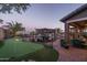 Extensive backyard with a putting green, pool, and covered patio at 43805 N Ericson Ln, New River, AZ 85087