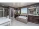 Bathroom with double vanity, soaking tub, and walk-in shower at 43805 N Ericson Ln, New River, AZ 85087