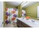 Well-lit bathroom featuring a double sink vanity and decorative floral shower curtain at 43805 N Ericson Ln, New River, AZ 85087