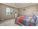 Cozy bedroom with a ceiling fan, bright window, and colorful bedspread at 43805 N Ericson Ln, New River, AZ 85087