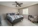 Bedroom features neutral walls, carpet flooring, ceiling fan and natural light at 43805 N Ericson Ln, New River, AZ 85087