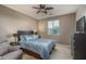 Comfortable bedroom featuring a full-sized bed, ceiling fan, and recliner at 43805 N Ericson Ln, New River, AZ 85087