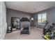 Exercise room with a treadmill, stationary bike and closet for storage at 43805 N Ericson Ln, New River, AZ 85087