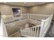 Second-story foyer with white railing overlooking staircase and lower level at 43805 N Ericson Ln, New River, AZ 85087