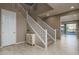 Welcoming foyer with a staircase, neutral paint, and tile floors leading into a spacious living area at 43805 N Ericson Ln, New River, AZ 85087