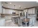 Spacious kitchen boasts a large island, granite counters, custom cabinets, and stainless steel appliances at 43805 N Ericson Ln, New River, AZ 85087