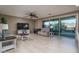 Bright living room features neutral colors, ceiling fan, tile flooring and sliding glass doors to backyard at 43805 N Ericson Ln, New River, AZ 85087