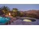 Enjoy scenic views by this custom pool and spa, accentuated by rock features and a charming fire pit at 43805 N Ericson Ln, New River, AZ 85087