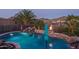 Resort-style pool with rock waterfall feature, fire pit, and lush tropical landscaping for ultimate relaxation and entertainment at 43805 N Ericson Ln, New River, AZ 85087