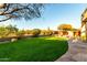 This spacious backyard features lush green lawn, desert landscaping and unobstructed views at 4546 E Sierra Sunset Trl, Cave Creek, AZ 85331