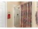 Bathroom showing a glass-enclosed shower with patterned shower curtain, door to the water closet and towel hooks at 4546 E Sierra Sunset Trl, Cave Creek, AZ 85331