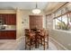 Eat-in kitchen features a wooden table with four chairs set on a decorative round rug at 4546 E Sierra Sunset Trl, Cave Creek, AZ 85331