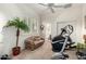 Bright room with a ceiling fan, carpet floors, weights, couch and exercise equipment at 4546 E Sierra Sunset Trl, Cave Creek, AZ 85331