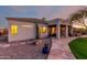 Exterior of home at dusk with stone walkway, desert landscaping, and covered patio with barbecue at 4546 E Sierra Sunset Trl, Cave Creek, AZ 85331