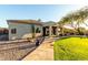 Exterior of home with stone walkway, desert landscaping, and covered patio with barbecue at 4546 E Sierra Sunset Trl, Cave Creek, AZ 85331