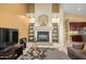 Living room showing fireplace with arched alcoves and shelving, TV area, and open floor plan at 4546 E Sierra Sunset Trl, Cave Creek, AZ 85331