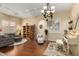 Bright and airy living room featuring hardwood floors, a decorative chandelier, and large windows with shutters at 4546 E Sierra Sunset Trl, Cave Creek, AZ 85331