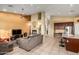 Spacious living room featuring a fireplace, ceiling fan, and an open concept layout into the kitchen and dining area at 4546 E Sierra Sunset Trl, Cave Creek, AZ 85331