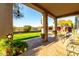 Covered patio offering scenic views of the landscaped backyard with vibrant greenery at 4546 E Sierra Sunset Trl, Cave Creek, AZ 85331