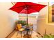 Cozy patio space with red umbrella, table and chairs in a private courtyard setting at 4546 E Sierra Sunset Trl, Cave Creek, AZ 85331