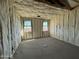 Interior room under construction with insulation, framing, and two windows providing natural light at 47463 W Kenner Dr, Maricopa, AZ 85139