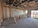 Interior view of a house under construction, showcasing the open layout, framing, and insulation at 47463 W Kenner Dr, Maricopa, AZ 85139