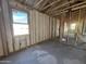 Interior view of a house under construction, with visible framing, insulation, and plumbing work at 47463 W Kenner Dr, Maricopa, AZ 85139